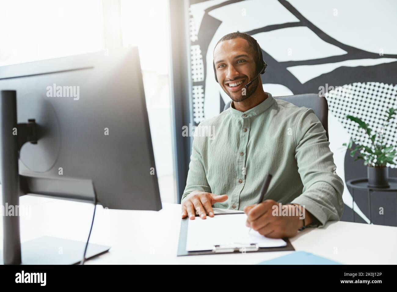 Man on computer making notes hi-res stock photography and images - Alamy