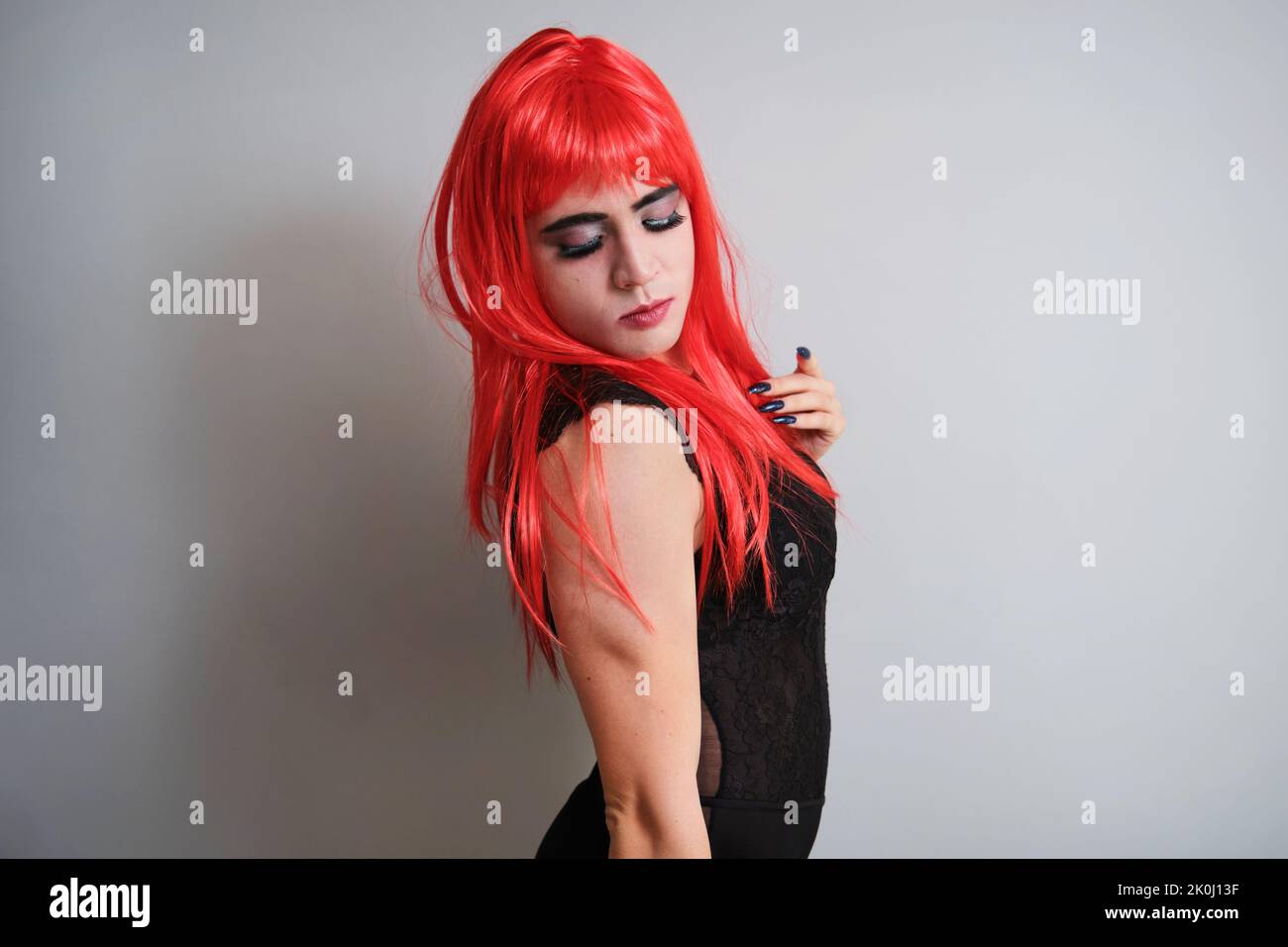 Portrait of gender fluid male dressed as female looking down Stock