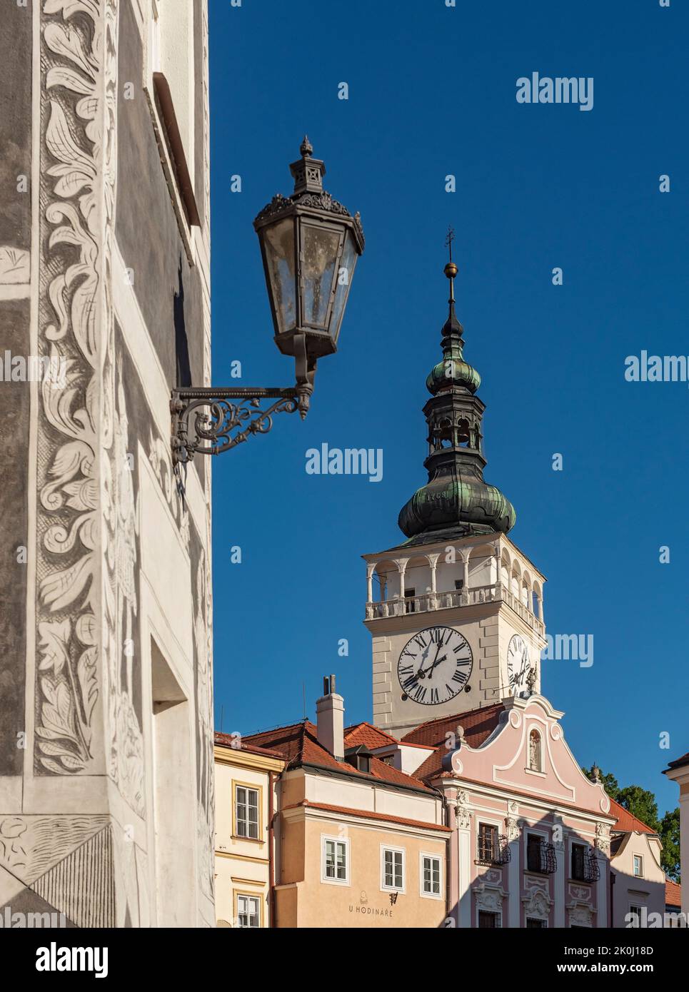 Street lamp on Knights (U Rytiru) house and tower of Church of St. Wenceslaus, Mikulov, Czech Republic Stock Photo