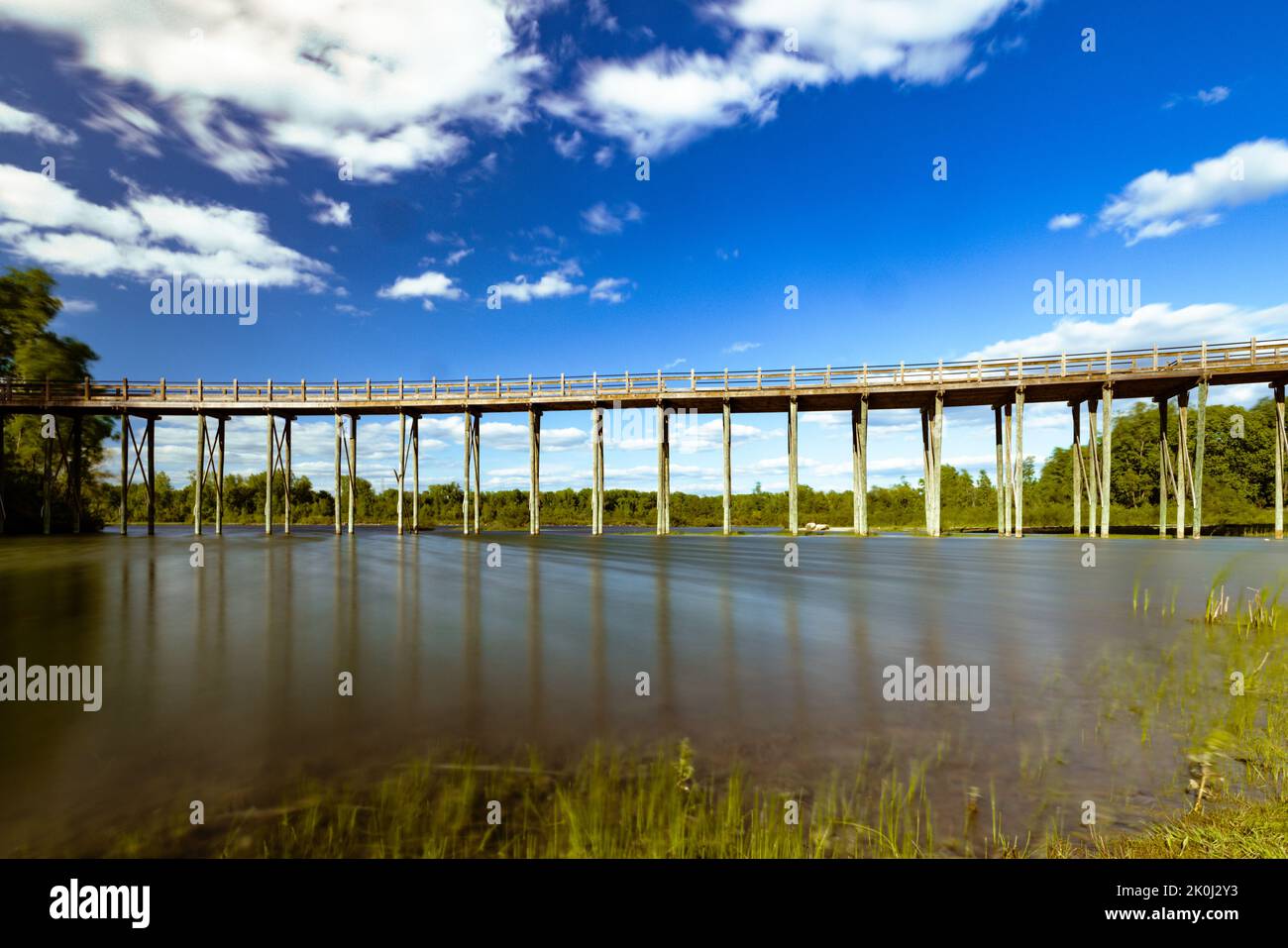 A long boardwalk bridge across a river in Michigan Stock Photo - Alamy