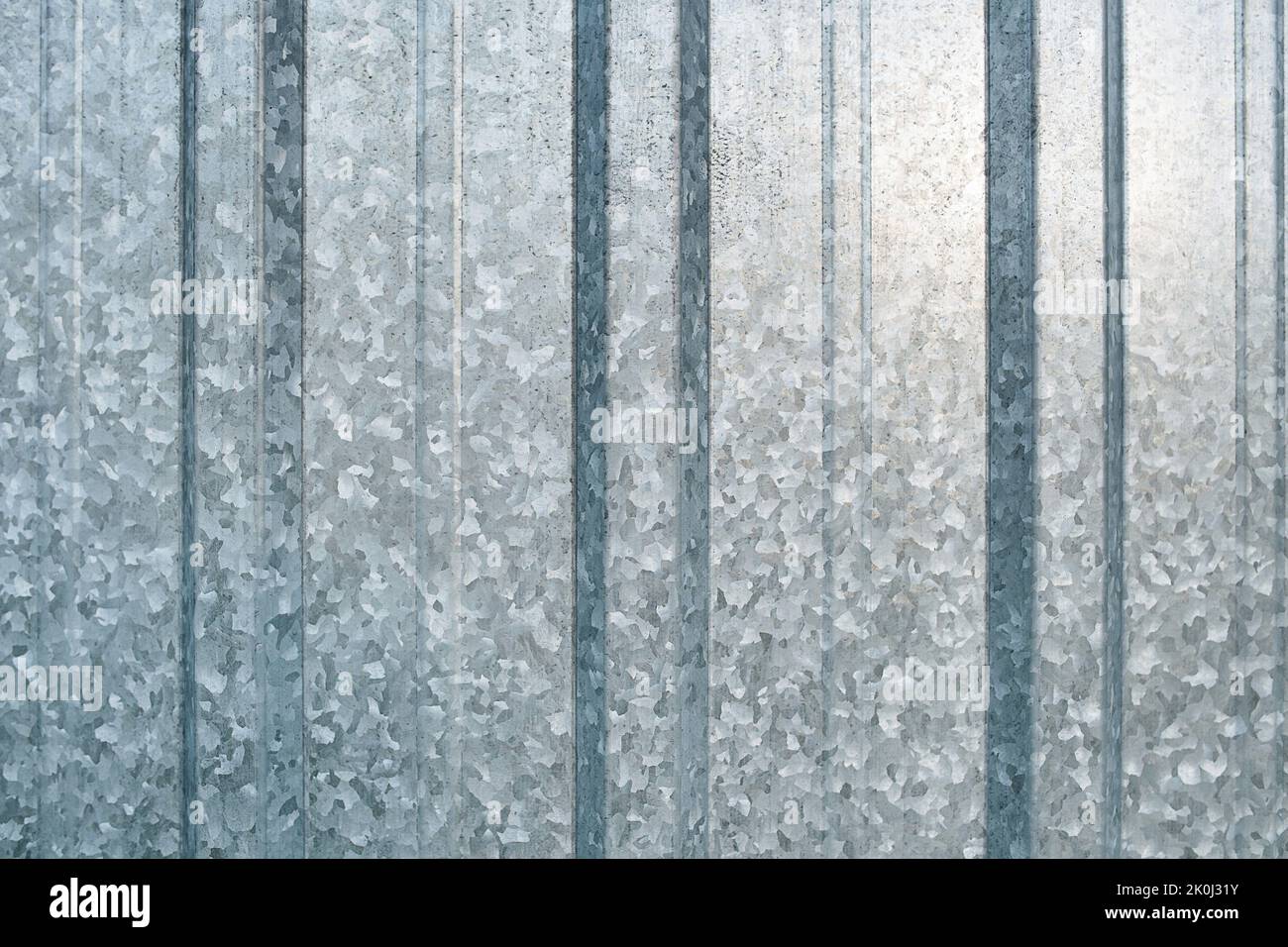 Stainless steel fence sheet texture close up. Raw unpainted with ridges and grooves Stock Photo