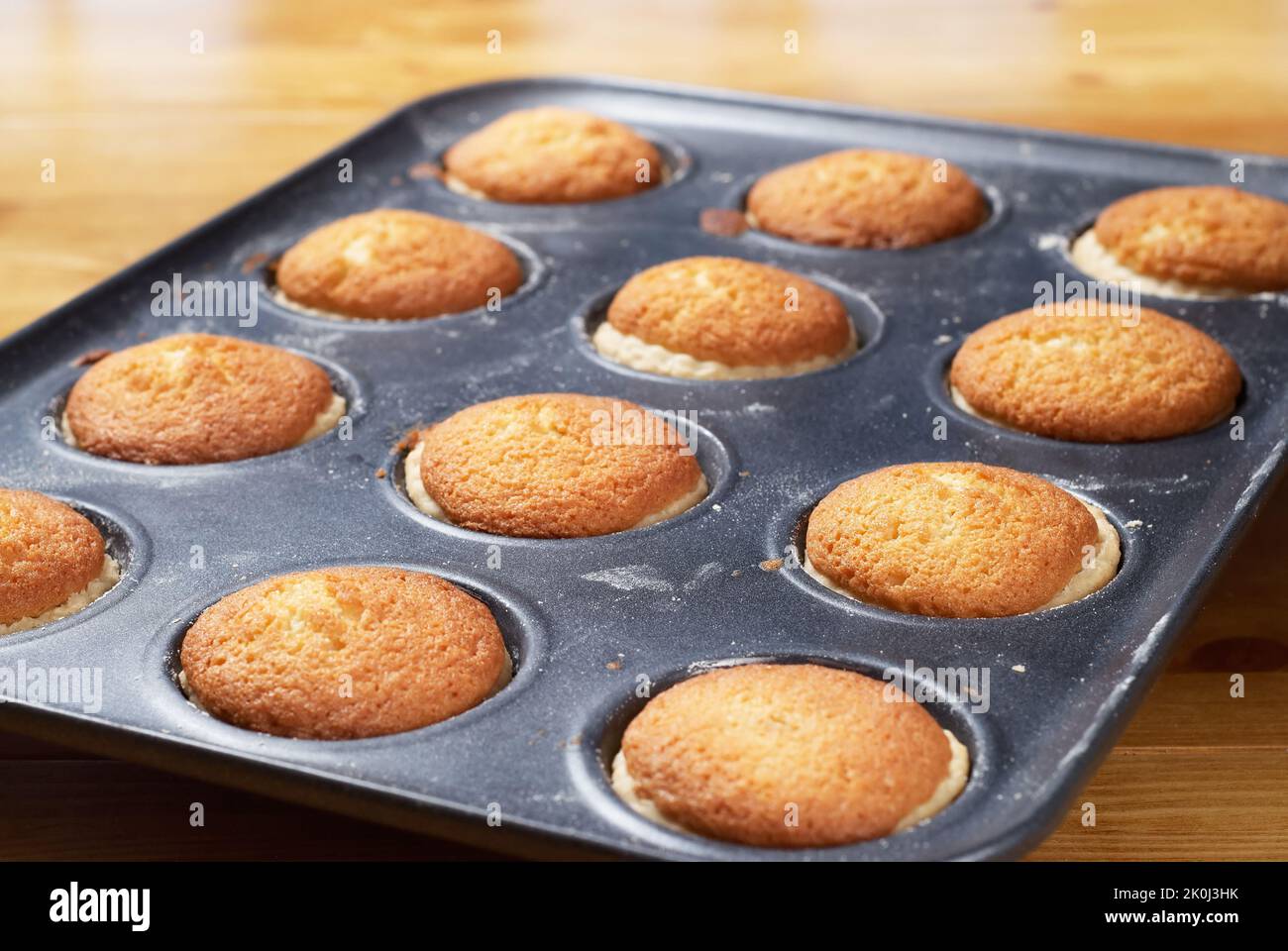 Freshly baked sweet buns on a baking tray. Fresh from the oven Stock Photo