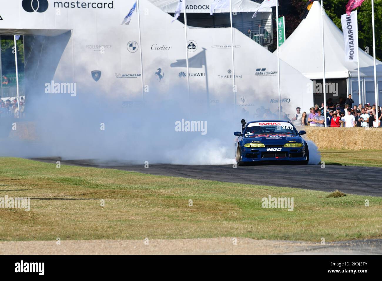 Axel Hildebrand, Nissan S14, The art of turning tyres into smoke in an artistic manner whilst driving between oil drums, Driftkhana, Goodwood Festival Stock Photo