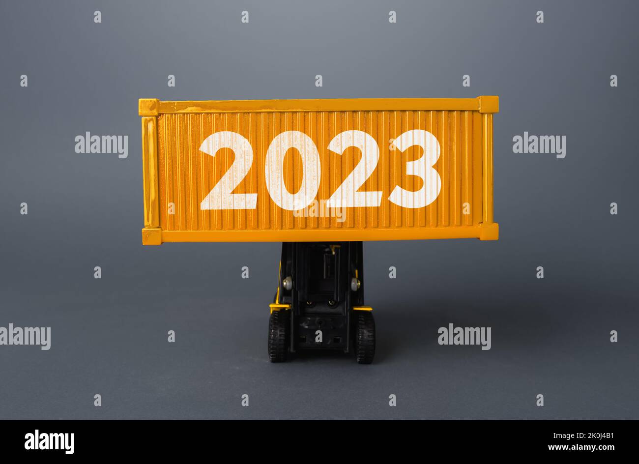 Forklift with a shipping container with 2023. Analytics forecasting of freight traffic next year. Develop infrastructure projects. Express delivery, g Stock Photo
