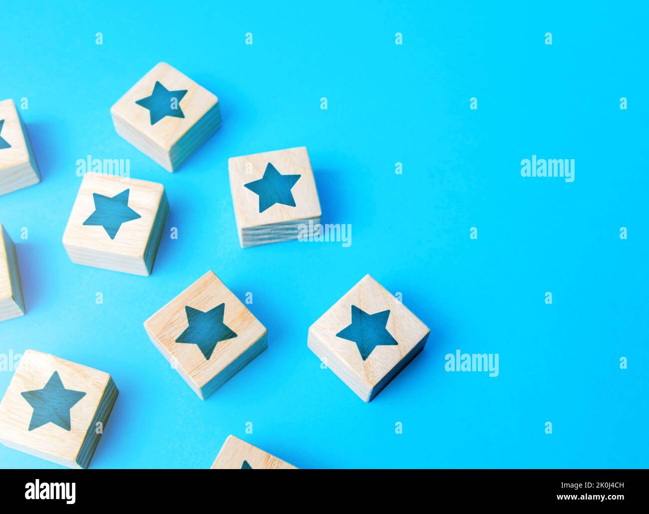 Scattered star blocks on a blue background. Popularity and fame. Feedback. Inspection, review. Benefits, positive things. New features. Ratings and re Stock Photo