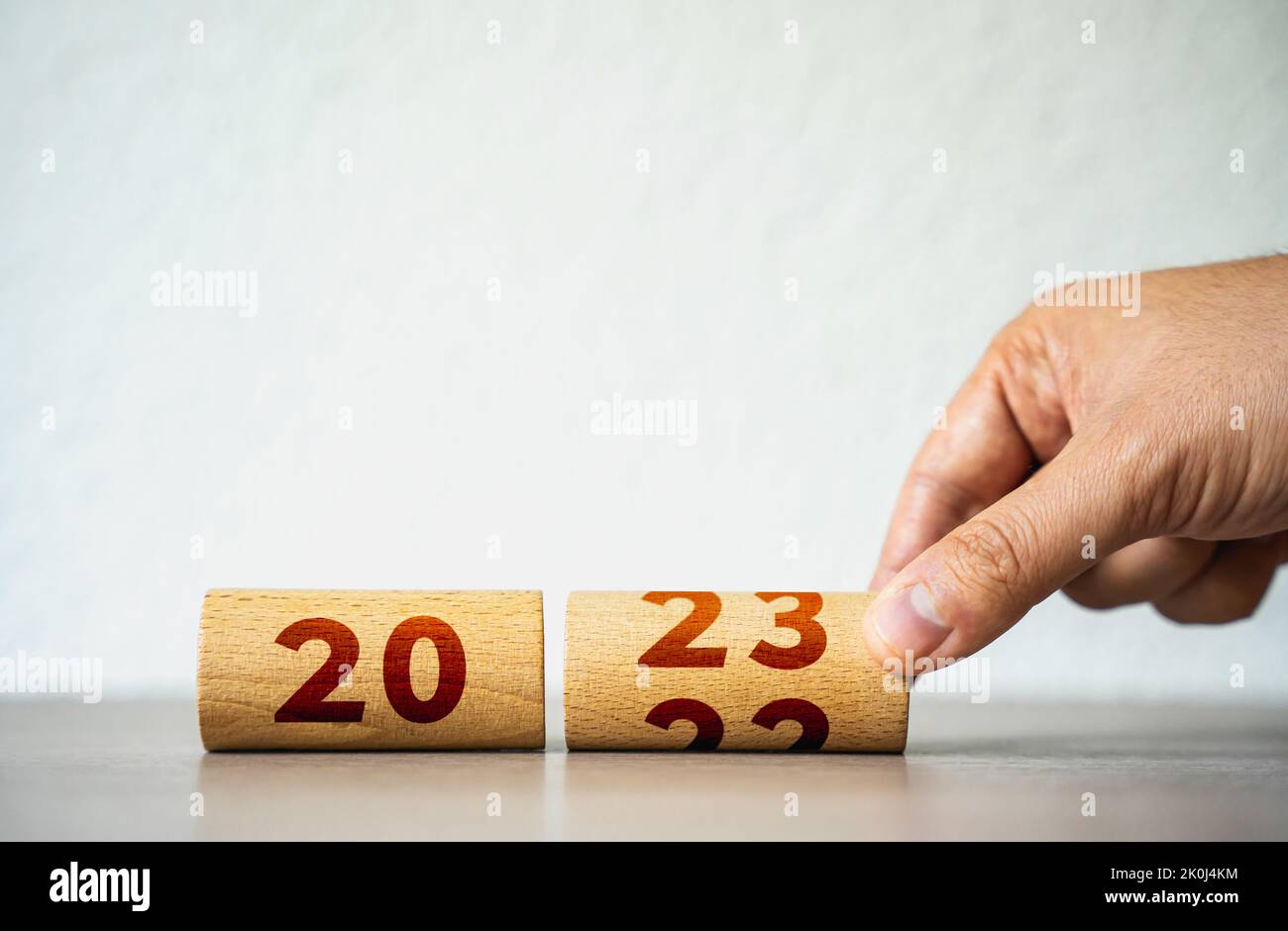 Wooden calendar flip for 2023. Christmas holidays. Trends and changes, challenges. A new beginning. Rethinking life and setting priorities. Set new pl Stock Photo