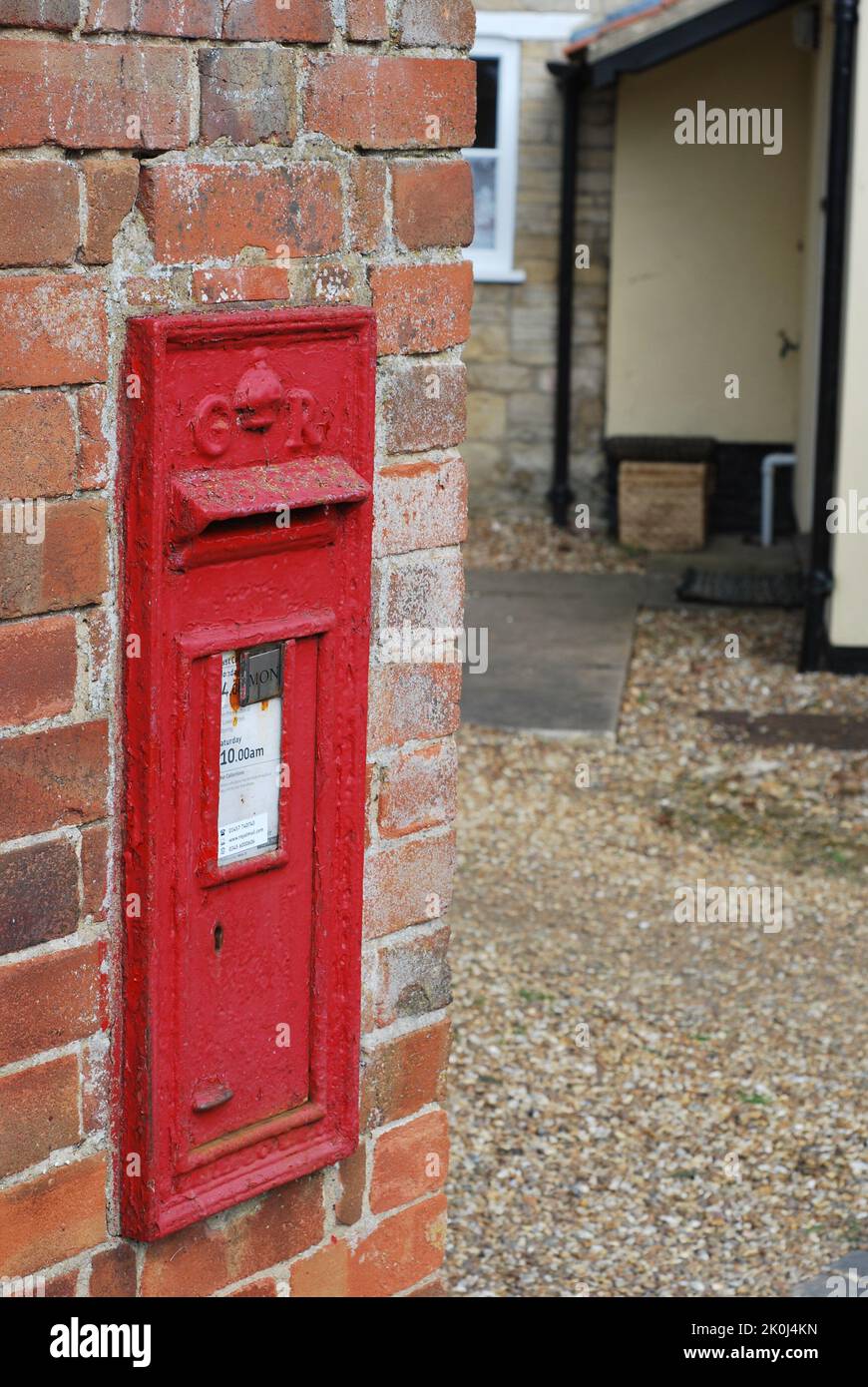 Red Letter Postbox in English country town with GR for King George V or VI in Thrapston, England Stock Photo