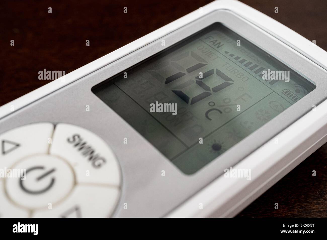 Close-up of a remote air condition with heating at 19 degrees on display related with the price energy crisis in europe for an expensive heating costs Stock Photo