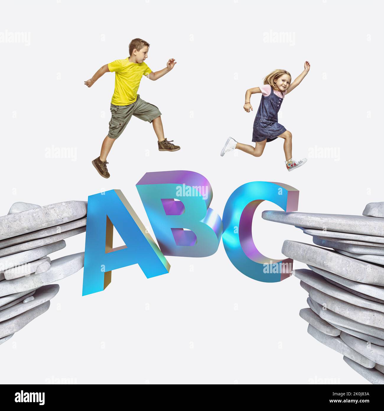 children run across a bridge made with letters. education concept. Stock Photo