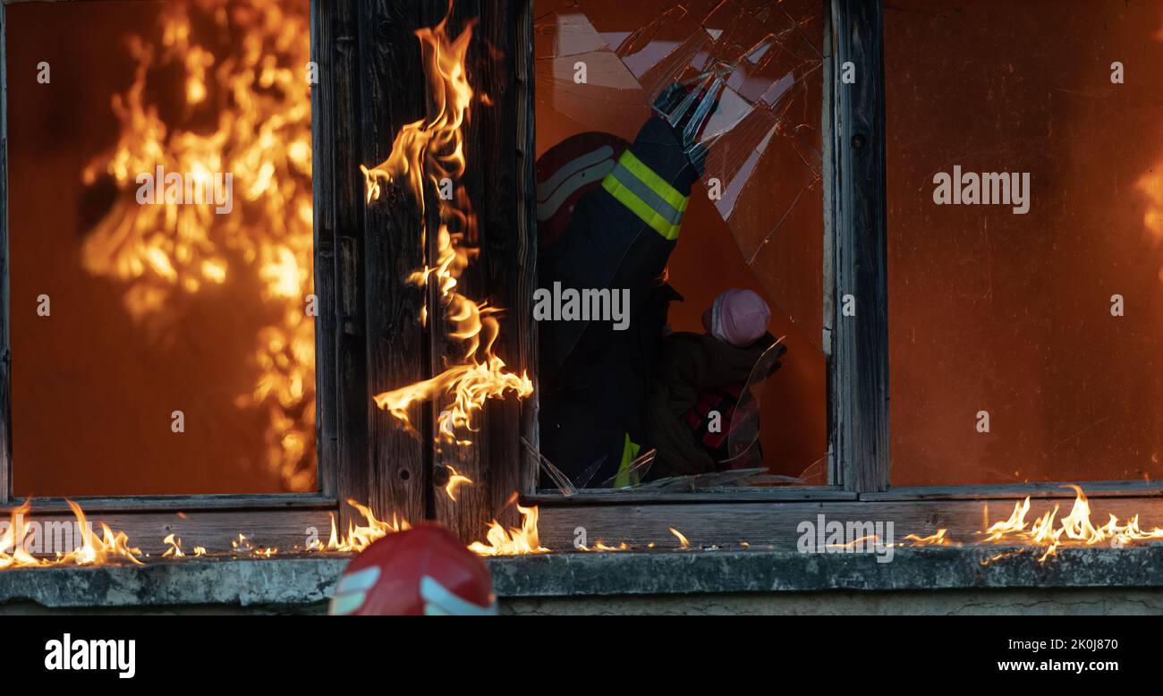 Firefighter hero carrying baby girl out from burning building area from ...