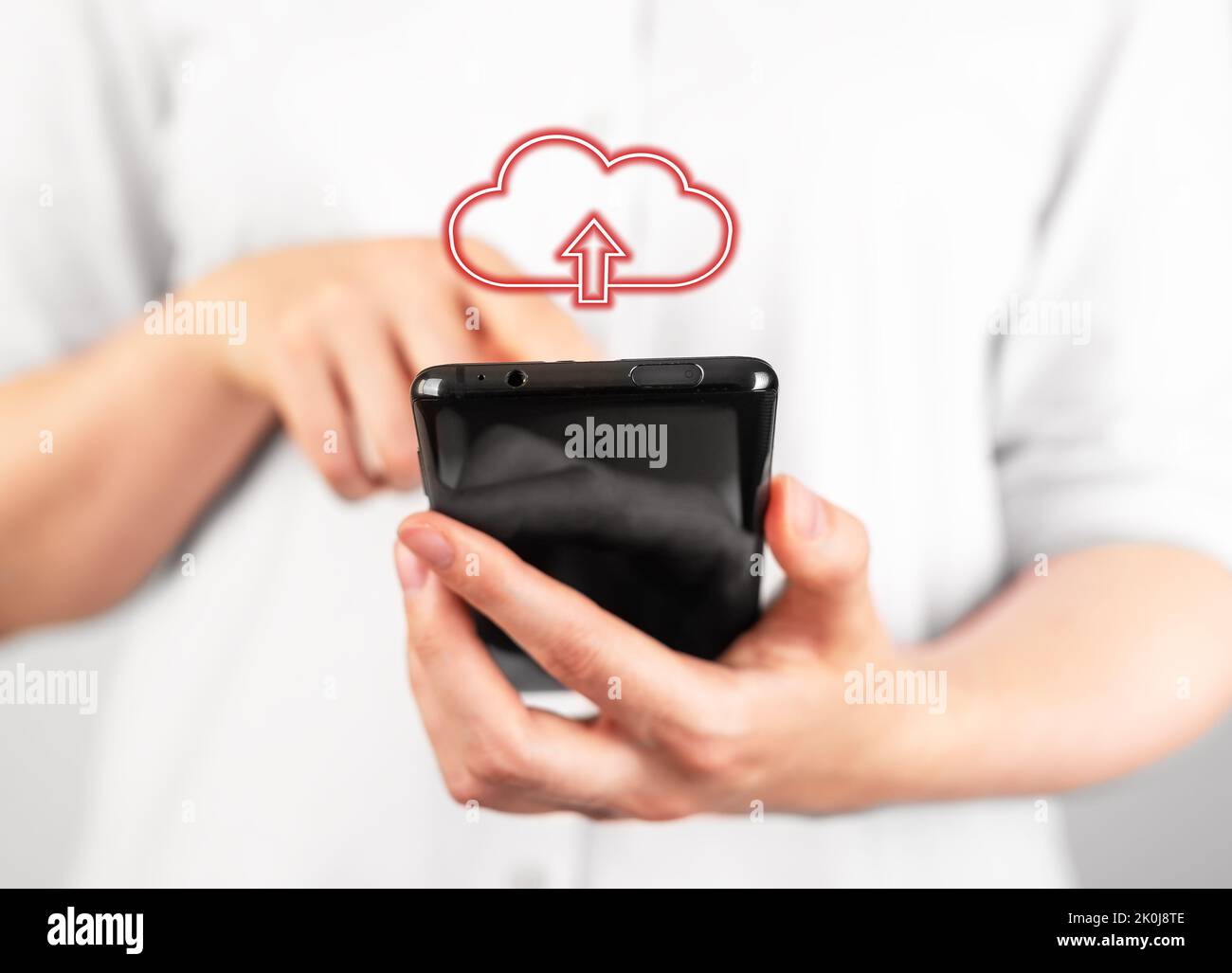 Woman holding phone for illegal file download. Online piracy concept. Unlicensed software programs, unauthorized application using. Mobile malware. Hi Stock Photo