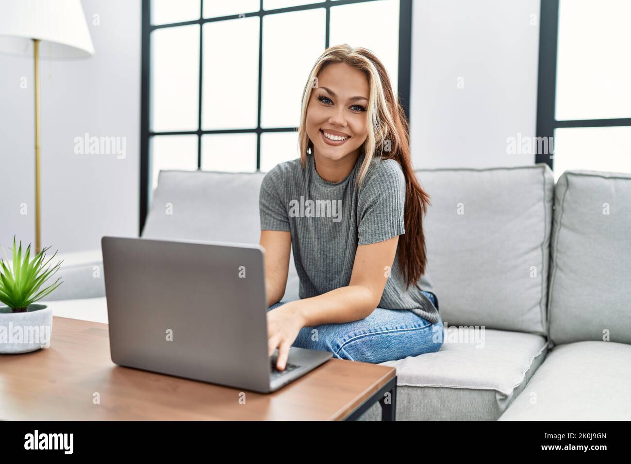 Young caucasian girl using laptop sitting on the sofa at home Stock ...