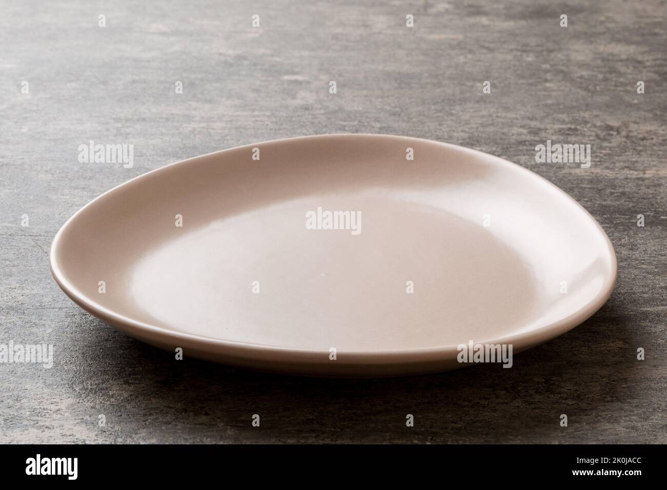 Perspective view of empty pink plate on cement background. Empty space ...