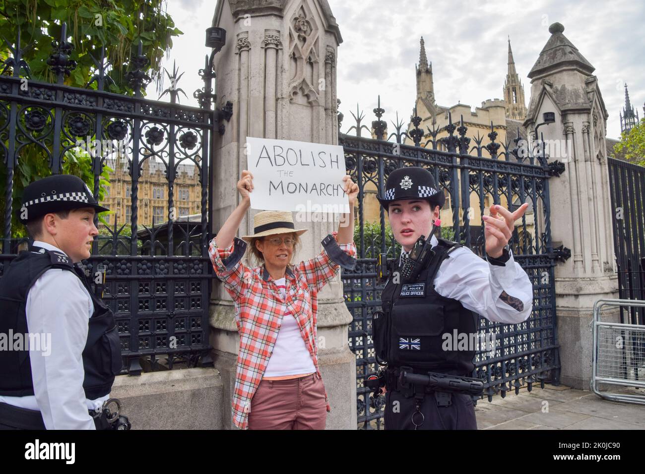London, UK. 12th Sep, 2022. Police move an anti-monarchy protester outside Parliament ahead of King Charles' arrival. King Charles III visited Parliament today to receive the Motion of Condolence. Credit: Vuk Valcic/Alamy Live News Stock Photo