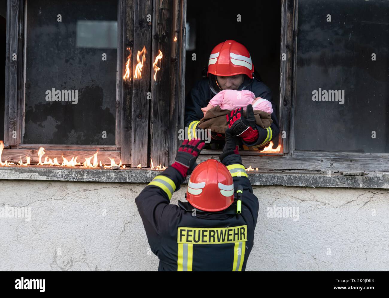 Firefighter hero carrying baby girl out from burning building area from ...