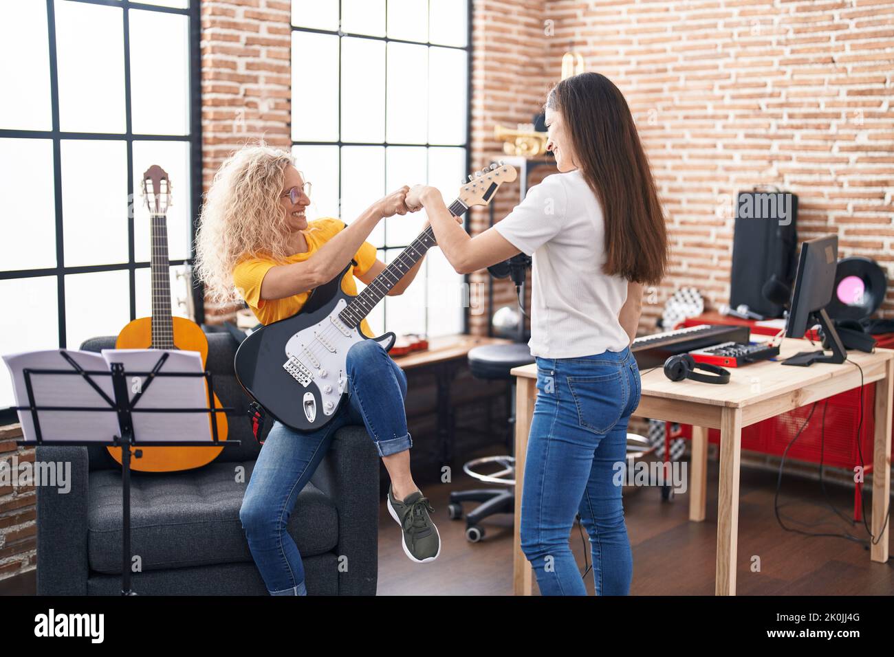 Two Women Musicians Bump Fists At Music Studio Stock Photo Alamy two-women-musicians-bump-fists-at-music-studio-stock-photo-alamy