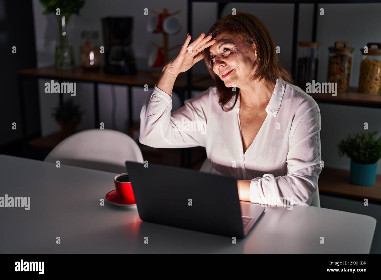 Middle age hispanic woman using laptop at home at night very happy and ...
