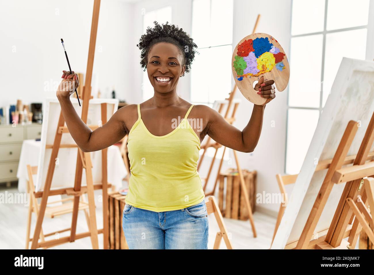 Young african american artist woman smiling happy drawing at art studio ...