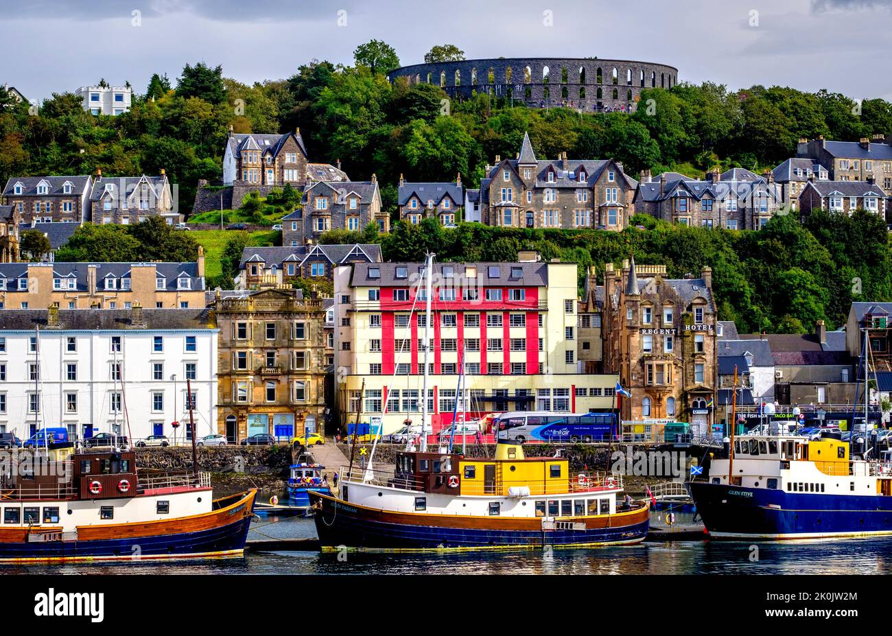 McCaig's Tower and Battery Hill high above the town of Oban on the west coast of Scotland Stock Photo