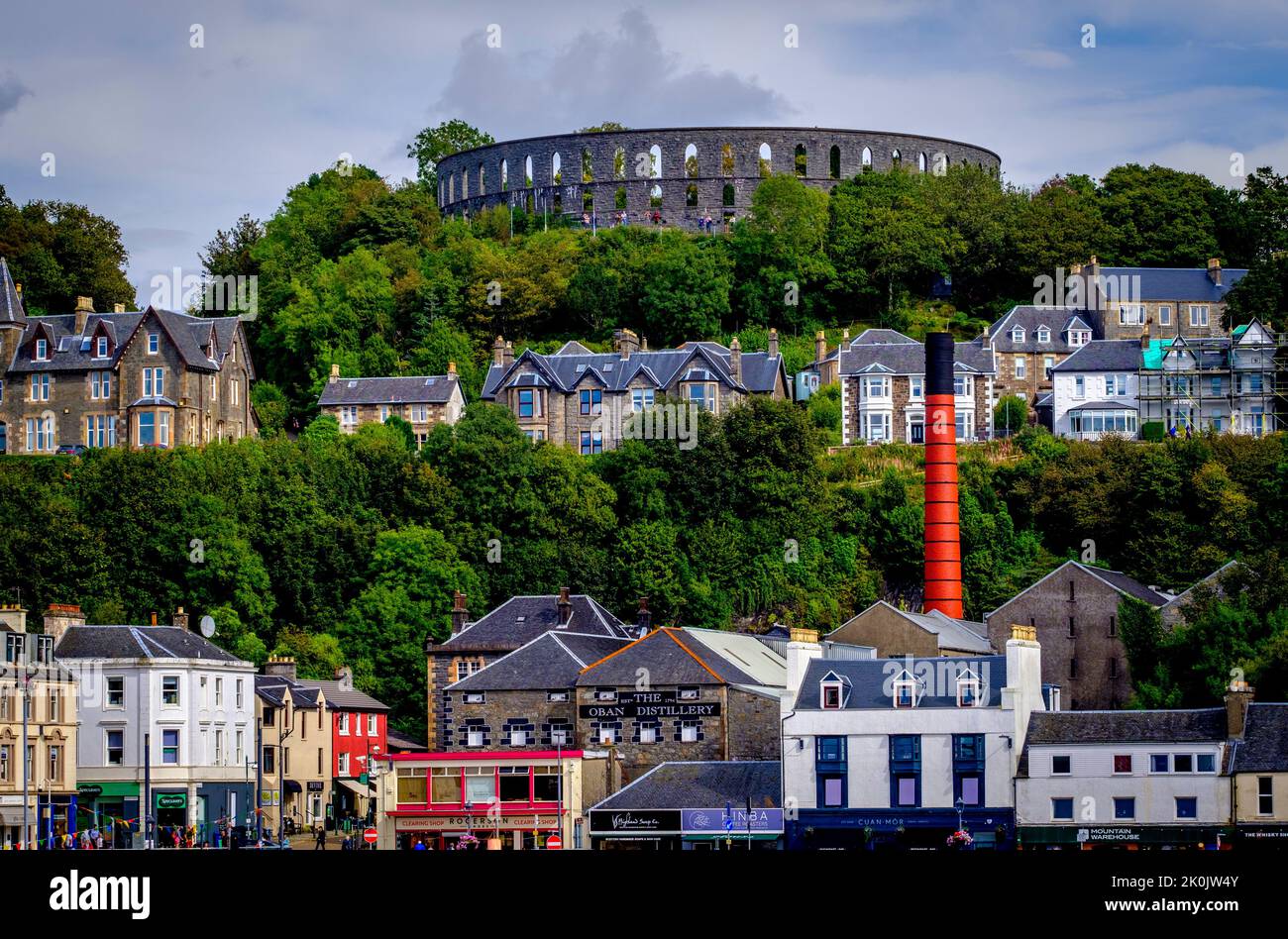 McCaig's Tower and Battery Hill high above the town of Oban on the west coast of Scotland Stock Photo