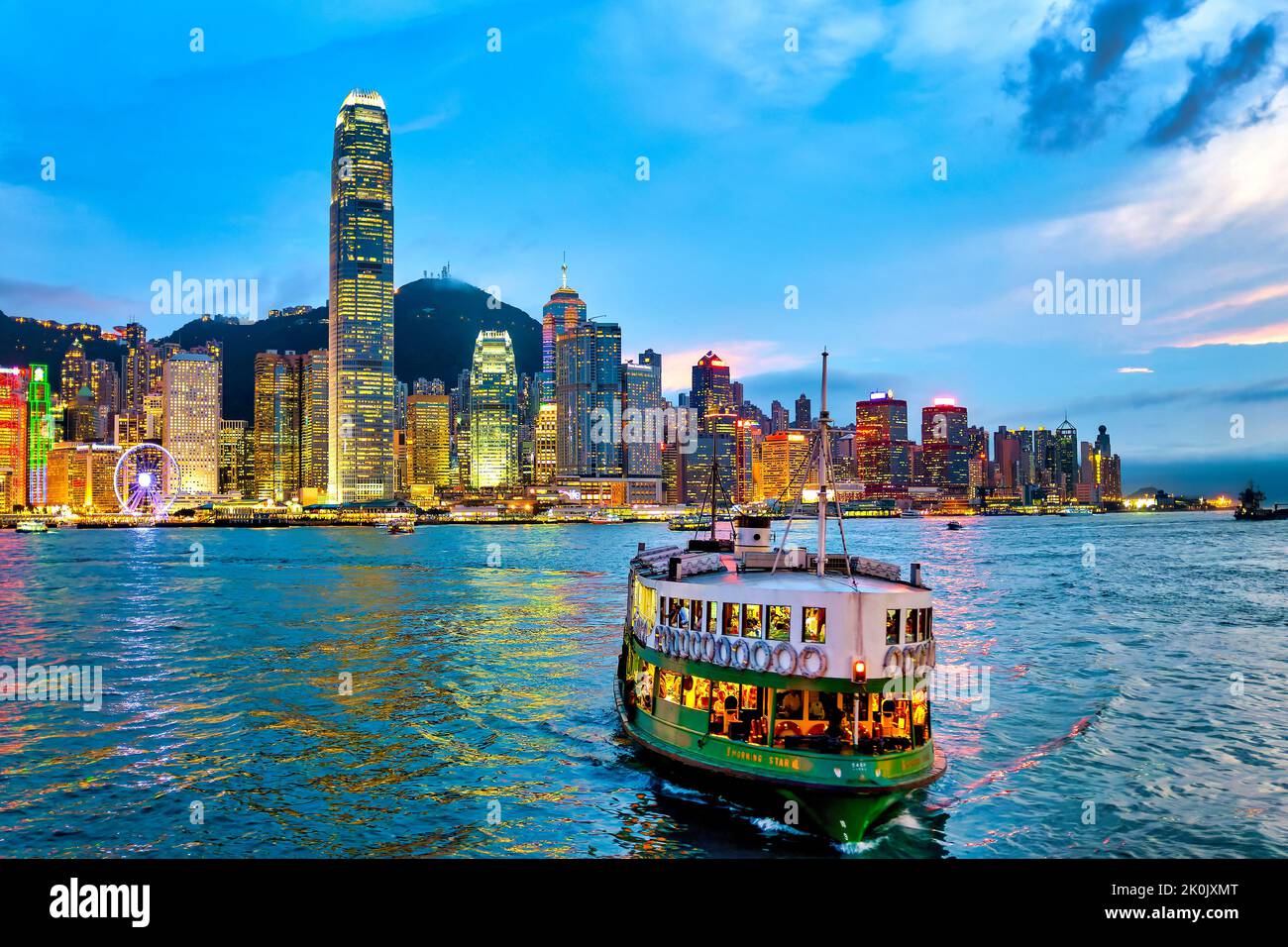 A star ferry in the Victoria Harbour at sunset, Hong Kong, China Stock Photo