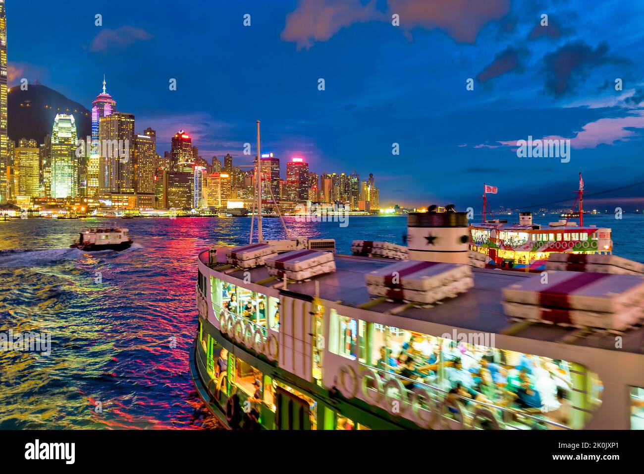 A star ferry in the Victoria Harbour at sunset, Hong Kong, China Stock Photo
