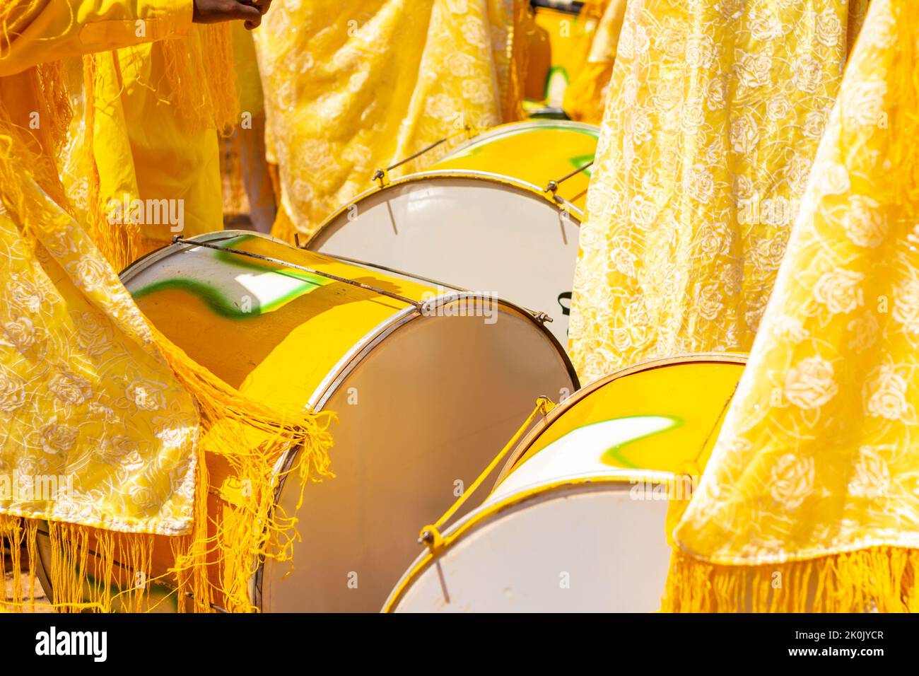 Goiânia, Goias, Brazil – September 11, 2022: Detail of some revelers using yellow drums during the Congadas, an Afro-Brazilian cultural and religious Stock Photo