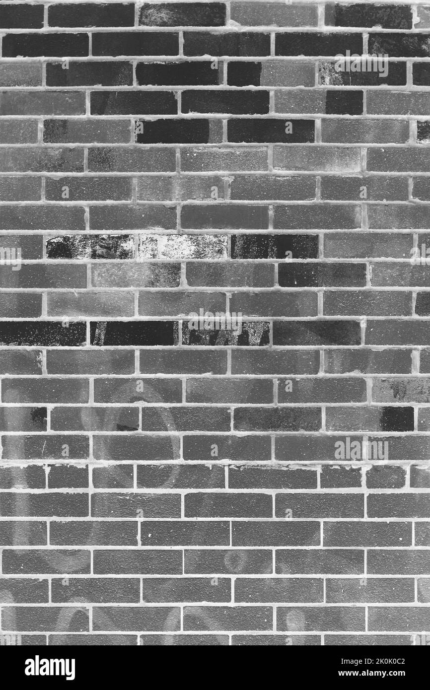 Typical common weathered brick wall in a black and white monochrome ...