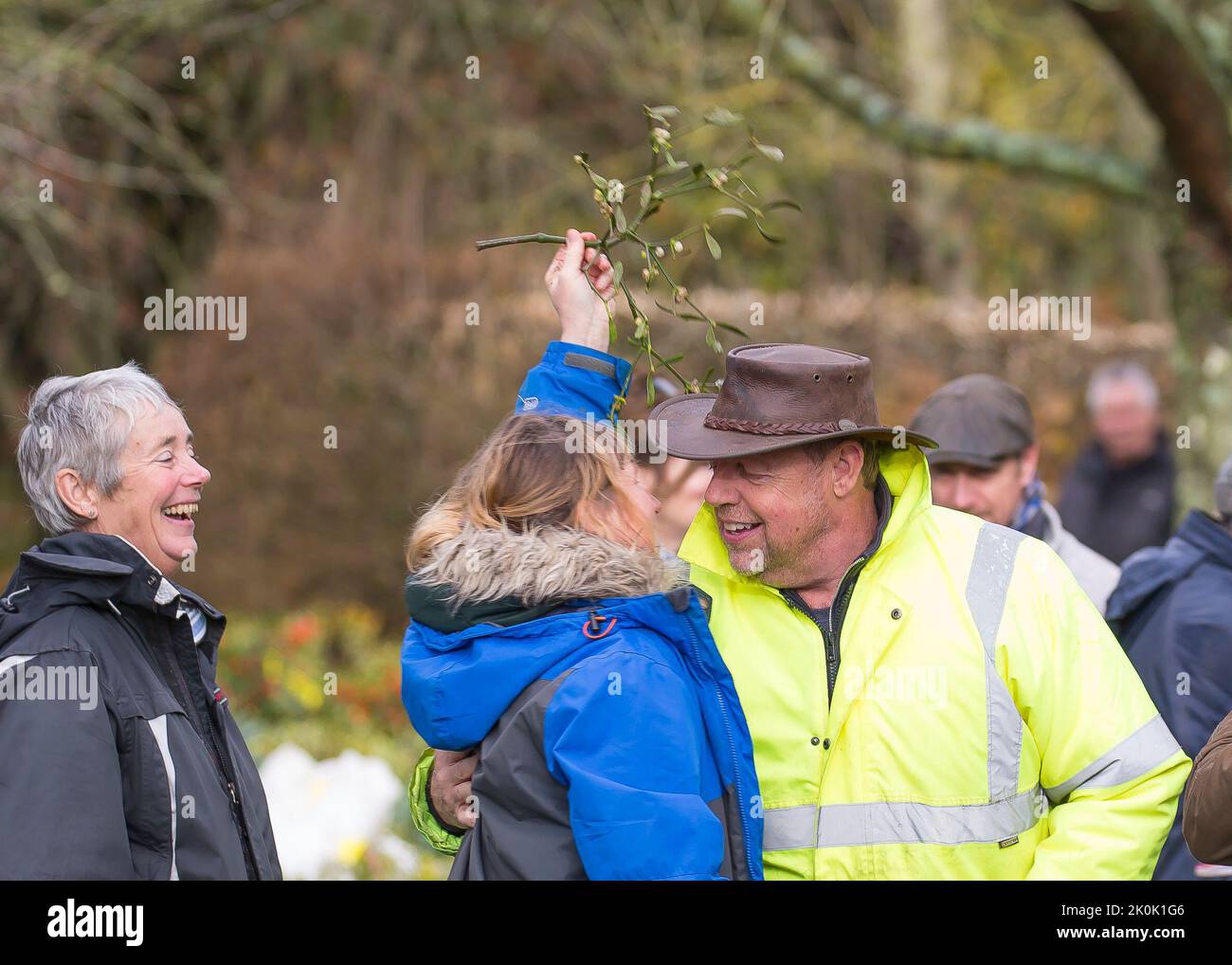 Tenbury Wells, UK. 26th November, 2019. Kissing under the mistletoe at Tenbury Wells annual Mistletoe and Holly Auction. In spite of the wet and dreary weather, nothing dampens the spirit of these UK buyers as they flock to the Worcestershire town of Tenbury Wells for the annual Mistletoe and Holly Auction. With UK farmers and growers offering such a staggering selection of freshly-cut, berry-laden lots for this event, buyers flock from far and wide to secure the finest festive foliage for their business' countdown to Christmas. Credit: Lee Hudson Stock Photo