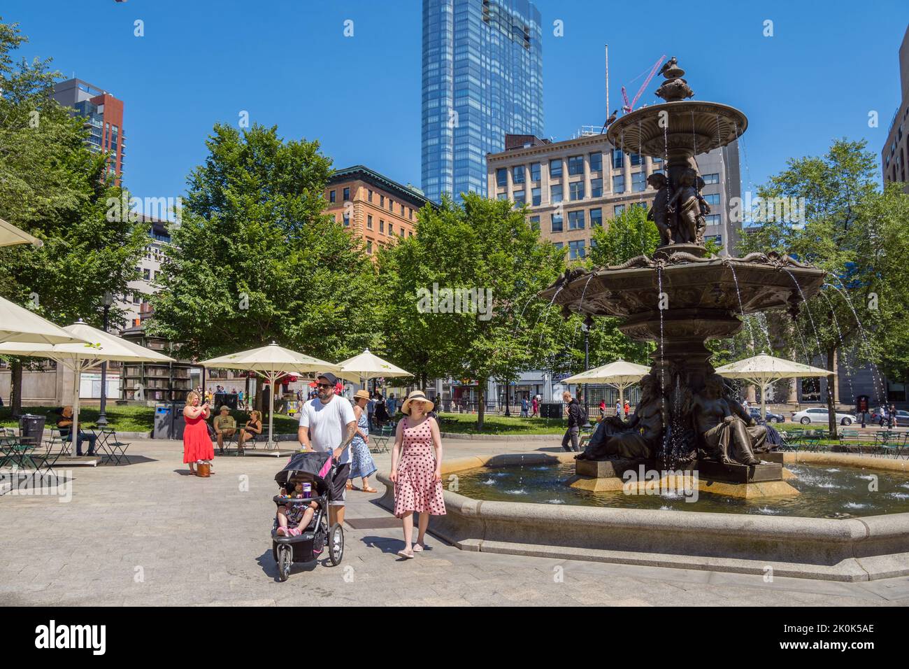 Boston, MA, US- June 25, 2022: People walk by fountain in urban park known as Boston Common. Stock Photo