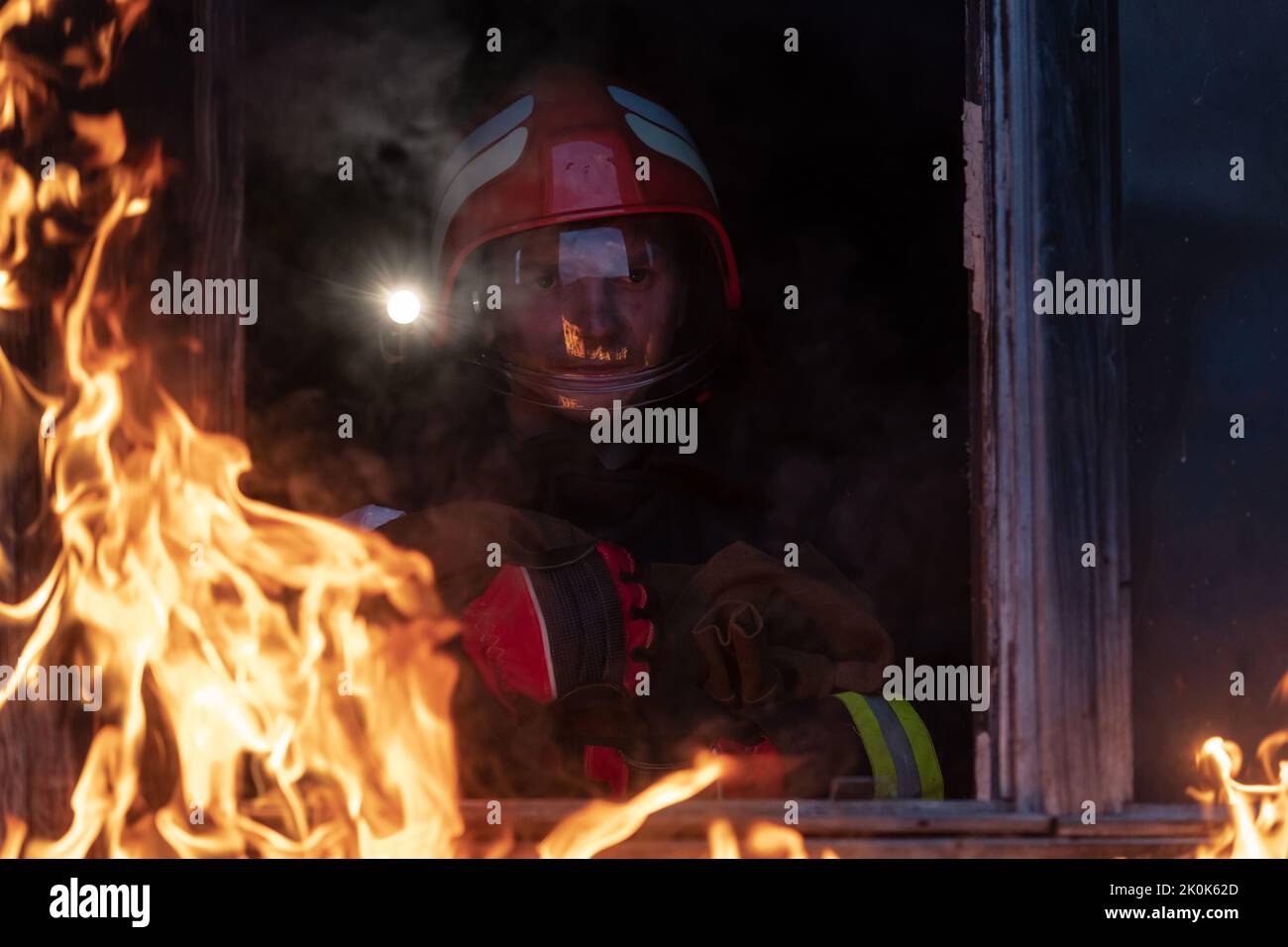 Firefighter hero carrying baby girl out from burning building area from ...