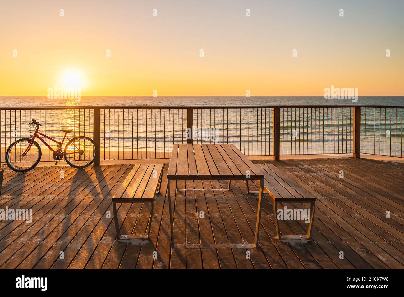 Picnic table on the beach at sunset, Somerton Park, South Australia Stock Photo