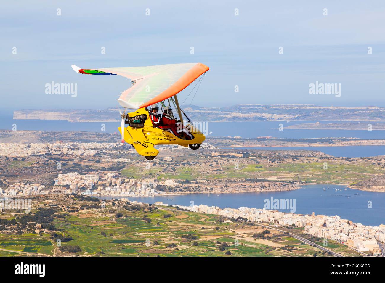 Apollo DeltaJet flexwing microlite flying above Malta with pilot and passenger. Air to air. Stock Photo