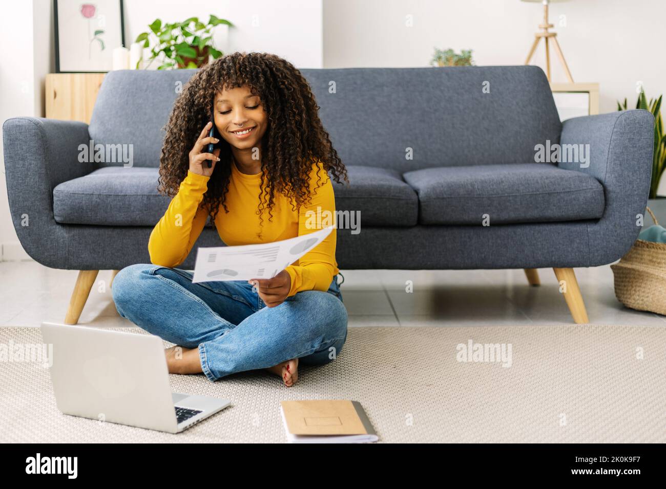 Young freelancer woman working on laptop computer while resting at home Stock Photo