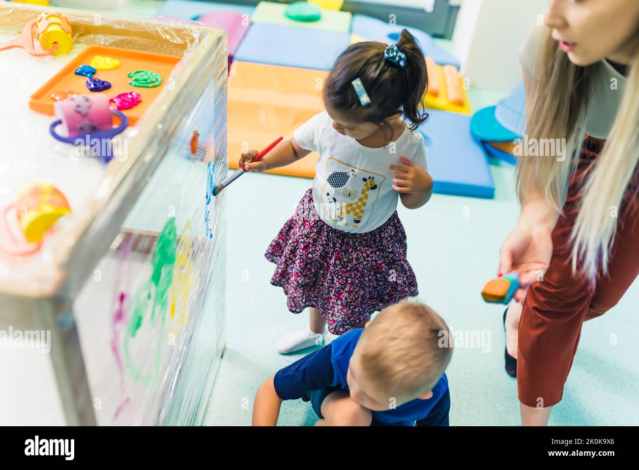 Cling film painting for improving kids imagination. Toddlers painting