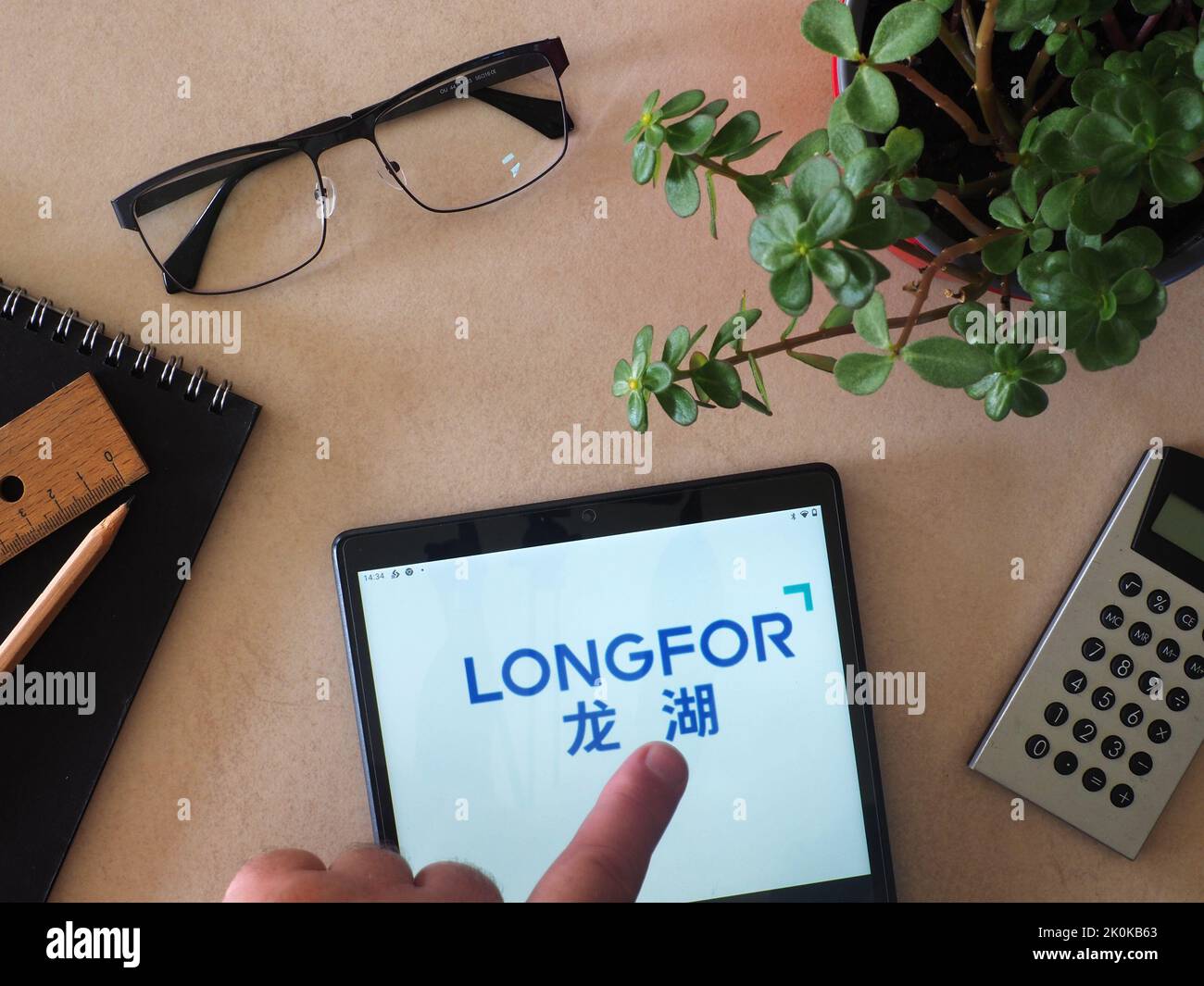 In this photo illustration, Longfor Group Holdings Limited logo seen displayed on a tablet Stock Photo