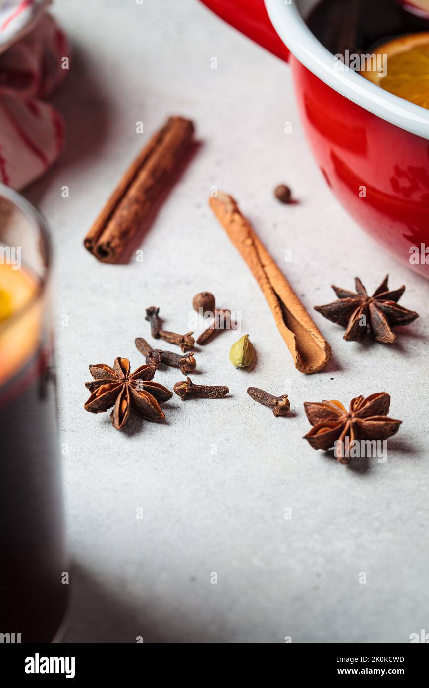 Spices for cooking mulled wine, close-up. Cinnamon, star anise, cardamom and cloves on a gray background. Stock Photo