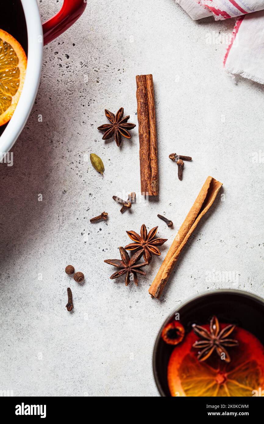 Spices for cooking mulled wine, top view. Cinnamon, star anise, cardamom and cloves on a gray background. Stock Photo