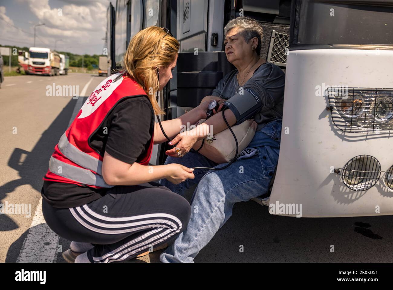 One refugee has to be treated for circulatory collapse during border clearance. Two buses left Mykolaiv in Ukraine to evacuate 110 refugees from the combat zone in Mykolaiv and the surrounding area. The refugees bid a tearful farewell to their relatives, who remained behind, before beginning their journey to Chisinau in Moldova. Stock Photo