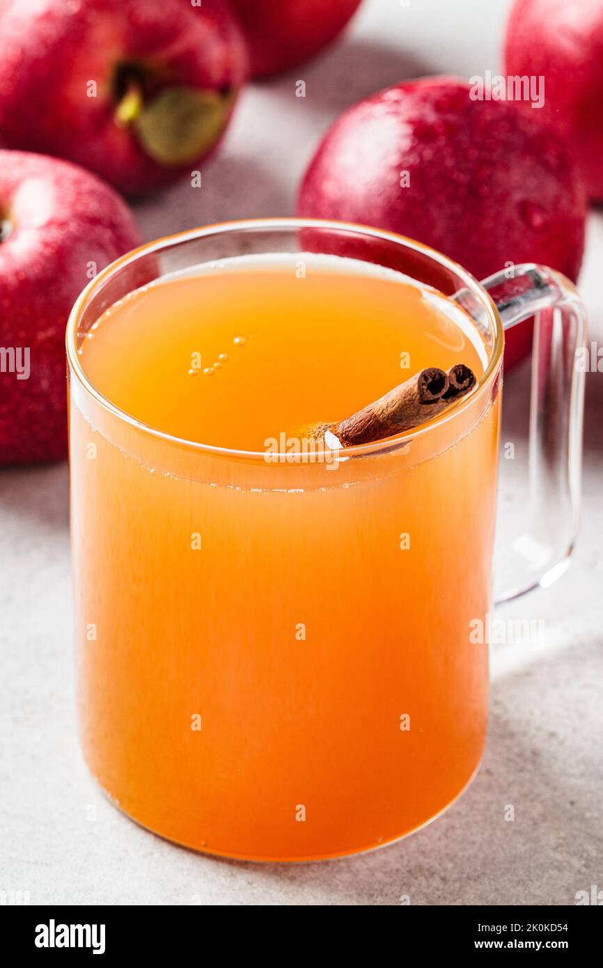 Homemade hot apple cider in a glass cup. Autumn or winter warming drink. Stock Photo