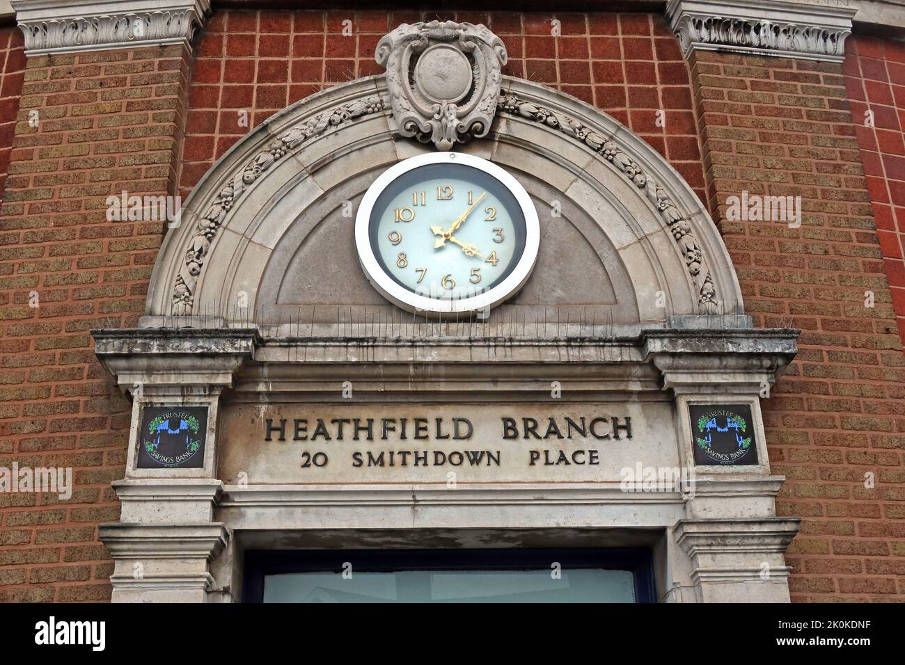 Old 'Penny Lane' 1930 Trustee savings bank entrance and clock, Heathfield Branch, 20 Smithdown Rd, Liverpool, Merseyside, England, UK, L15 5AJ Stock Photo