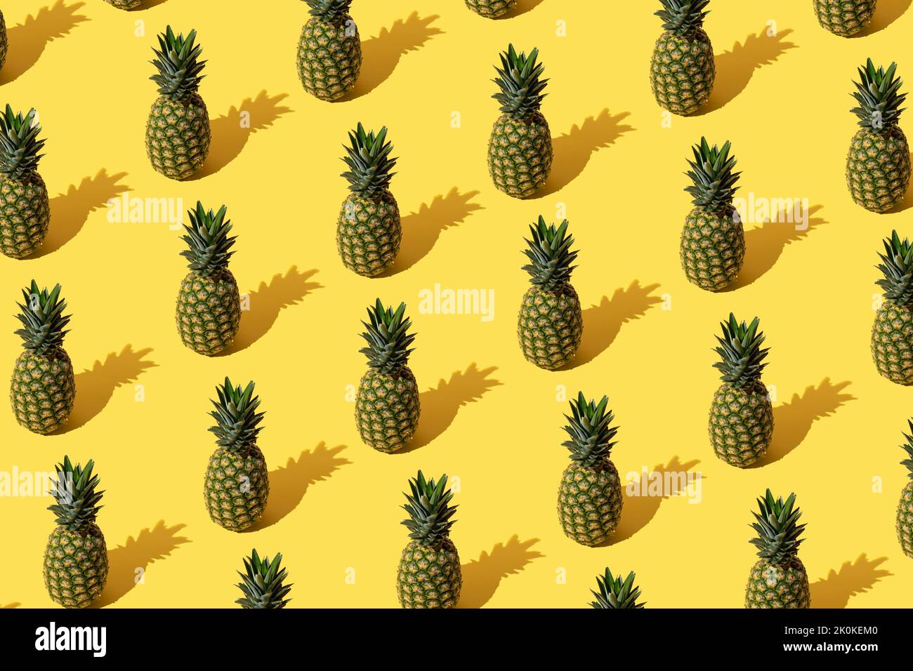 Summer pattern with pineapples on yellow background. Stock Photo
