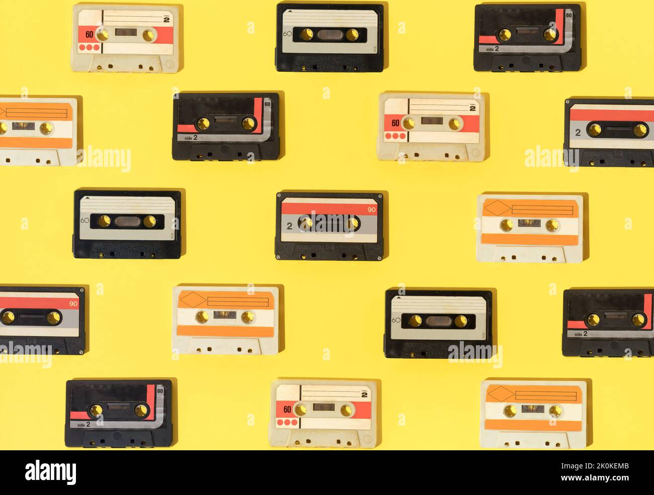 Retro pattern with audio cassettes on yellow background. Stock Photo