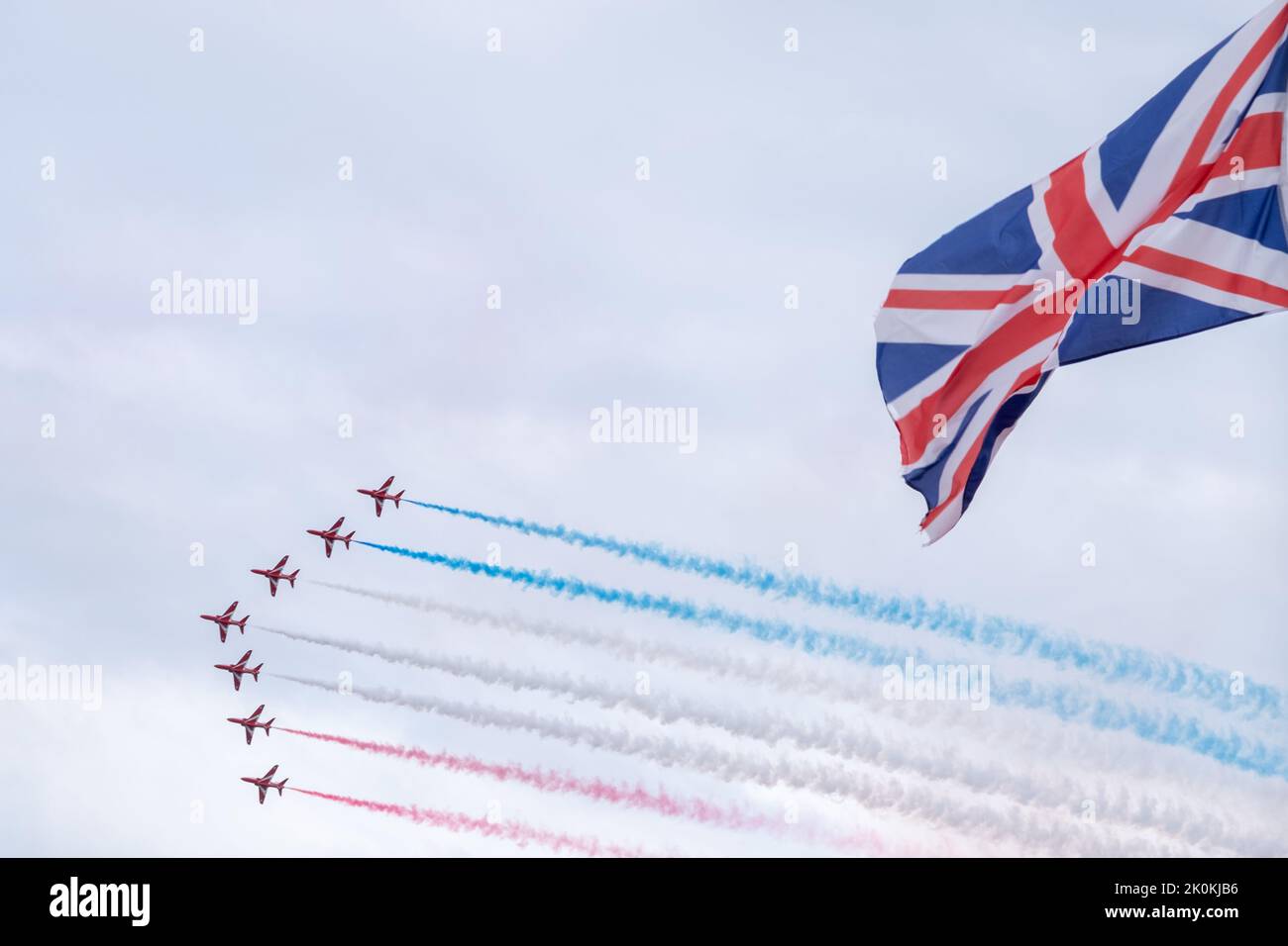 Red Arrows fly pass Union Jack Flag, Teignmouth air show, England, UK Stock Photo