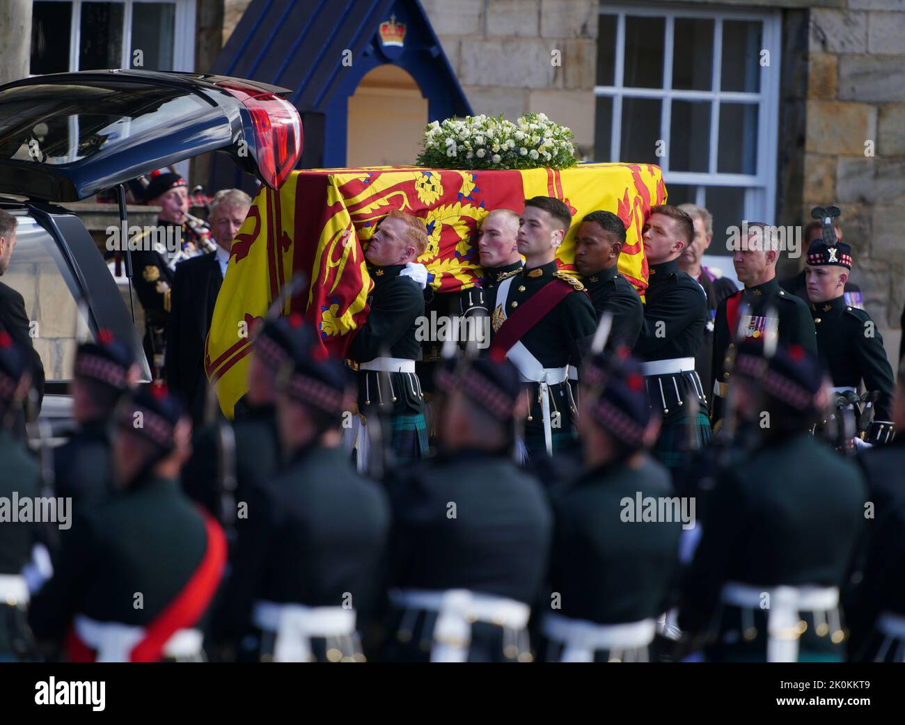 RETRANSMITTING AMENDING BYLINE Royal guards carry Queen Elizabeth II's