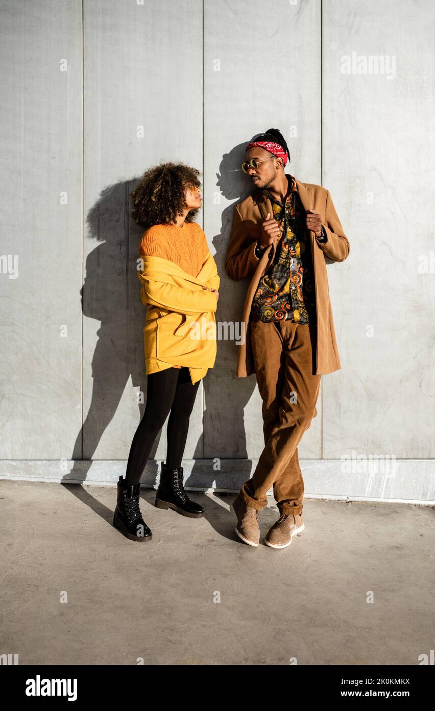 Full length of black African American couple in trendy vivid warm ...