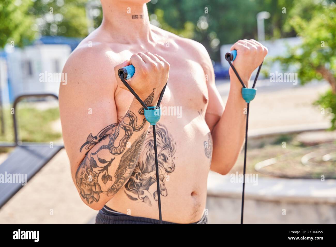 unrecognizable man training with rubber bands outdoors Stock Photo
