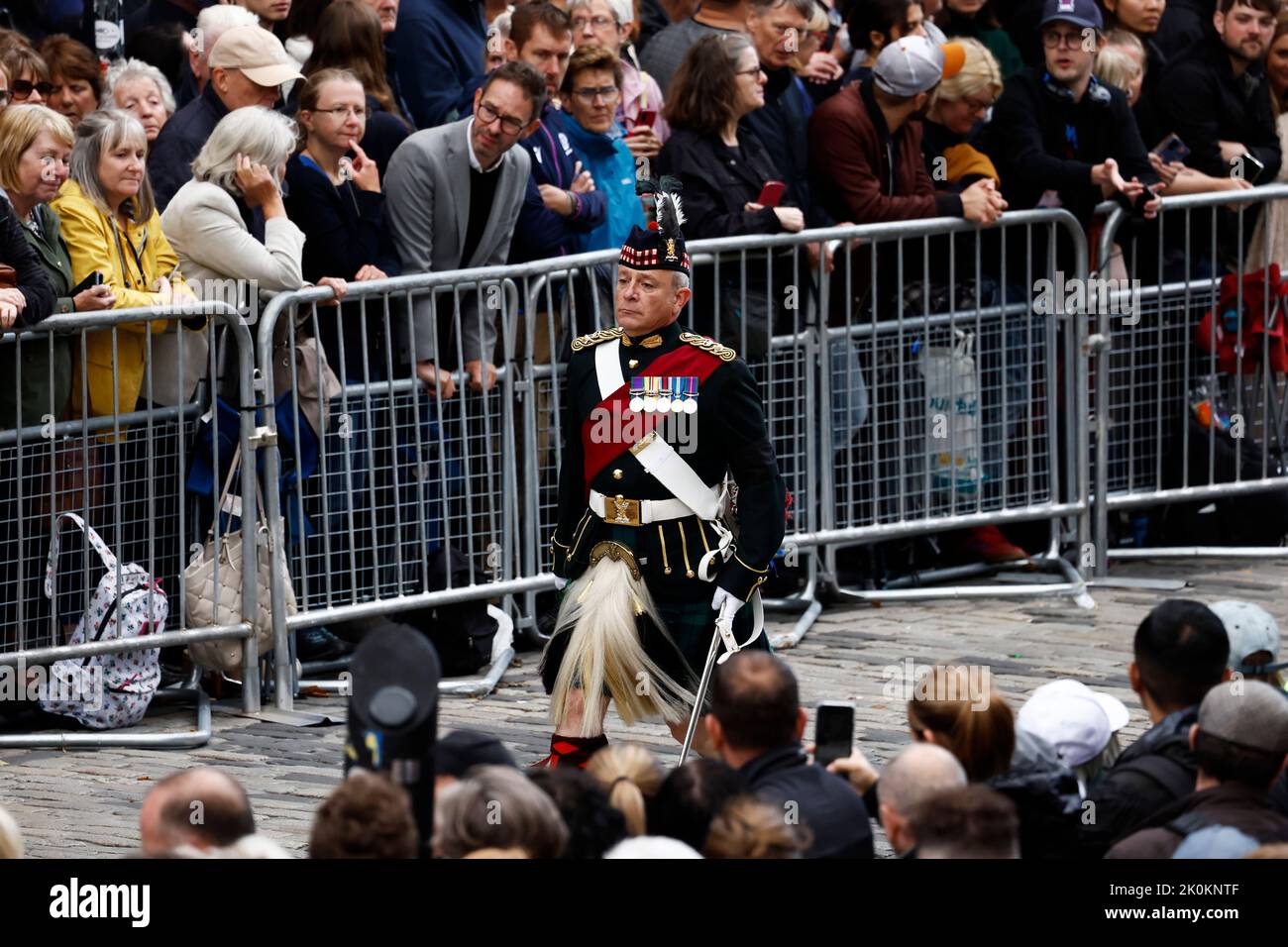 A soldier walks near Mercat Cross ahead of the procession of Queen