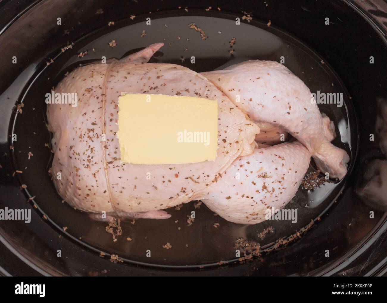 Ready to cook whole chicken in slow cooker Stock Photo