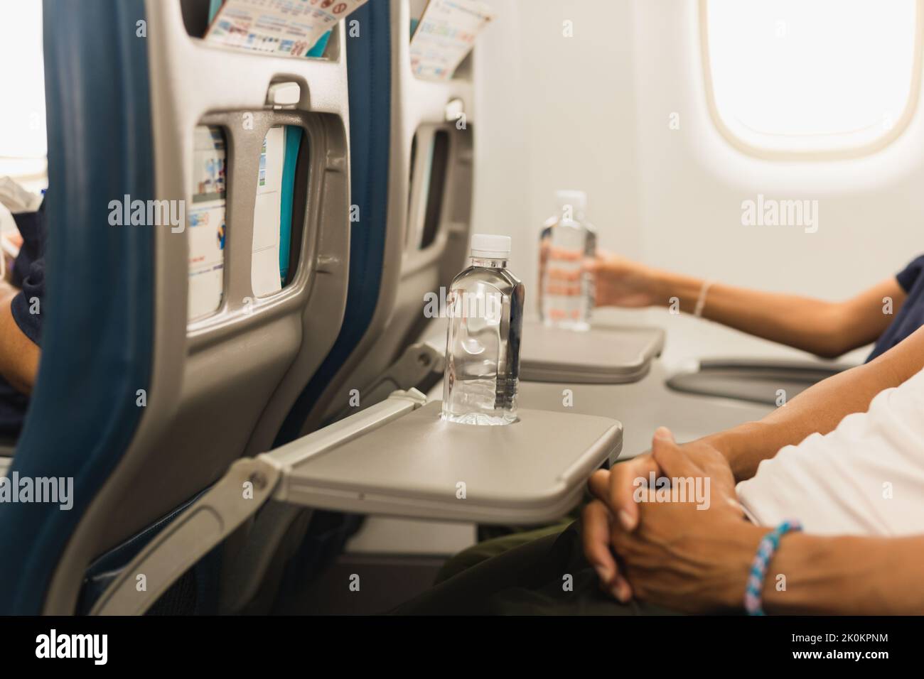 Bottle of water on the aircraft for drinking on the flight Stock Photo